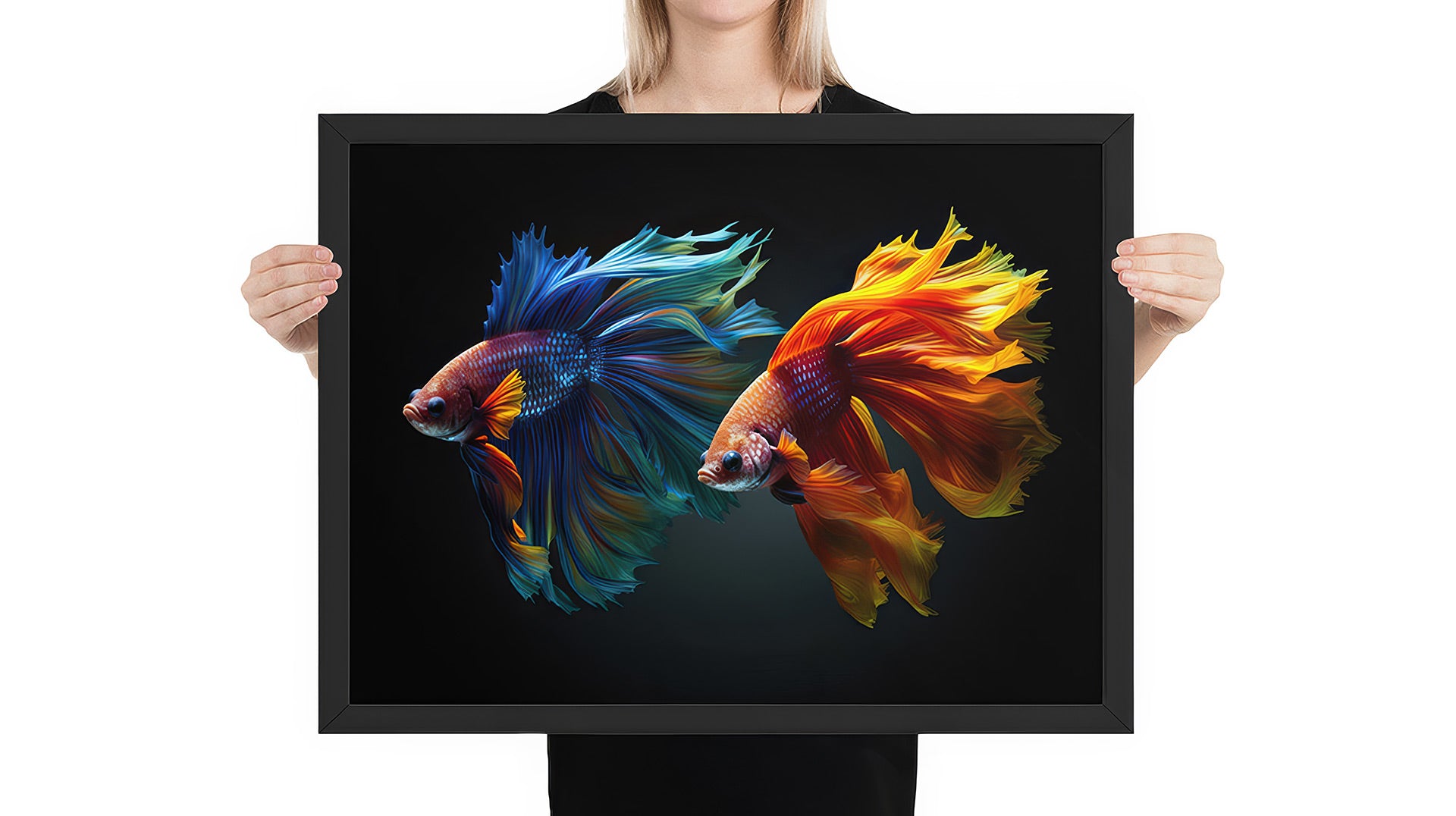 Person holding framed artwork of 2 colorful beta fish